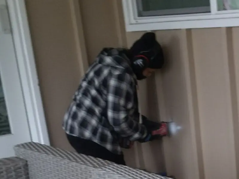 Professional electrician installing an exterior outlet in Lawrenceburg